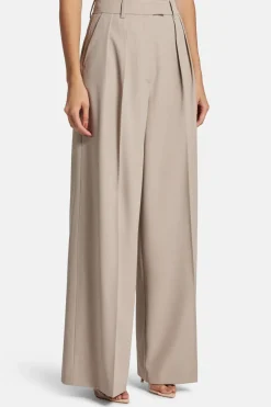 Lou High Waisted Flared Wool Trousers in Beige